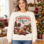 Female model wearing the Books, Cocoa & Christmas Cheer sweatshirt